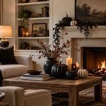 Halloween decor ideas in a warm living room with black pumpkins, dried branches, and candles